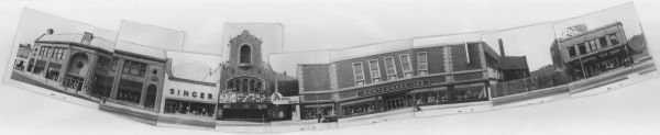 Composite panoramic view of the south side of the 100 block of State Street. Businesses include: Yost's, Singer, the Capitol Theatre (showing "Africa: Texas Style"), Arenz Shoes (out of business), Montgomery Ward, and Capitol Tog Shop. There is a vacant lot between Montgomery Ward and Capitol Tog Shop with a heavily graffitied fence. Two men look under the hood of a car parked along the curb.