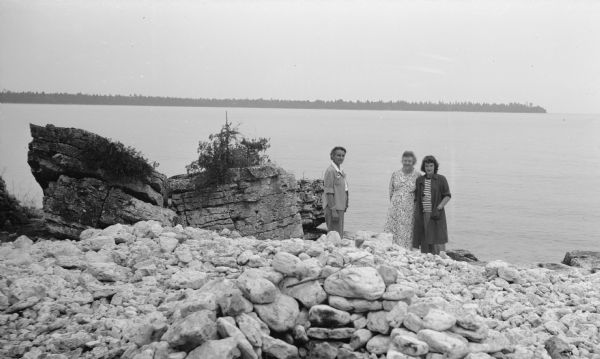 The photographer's daughter, Helen Hotz Schmid, left, and granddaughter, Margaret Schmid, right, pose at water's edge with Nenn Steck Hotz at Toft Point near Bailey's Harbor.
