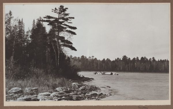 A ship lies grounded in the shallow waters of Mud Bay (part of Moonlight Bay), off Toft Point.