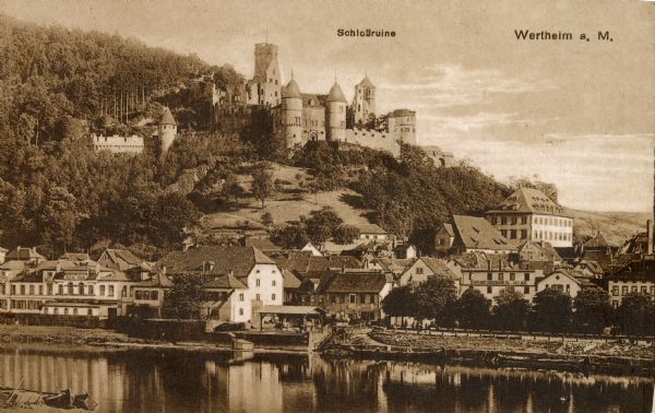 The castle ruins (Schlossruine) stand on a hill above the town of Wertheim, Baden, Germany. The Main River is in the foreground. The Hotel Held is seen at lower left.
