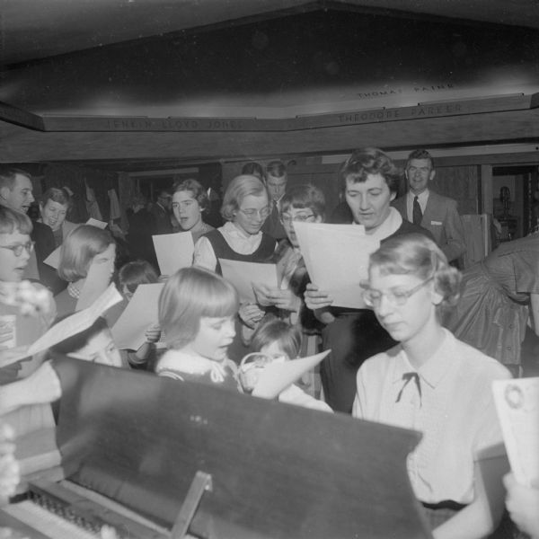 An undated musical event for children at the First Unitarian Society Meeting House. The photograph, which was taken by Herb Jacobs, a member of the society, shows the ceiling of the Hearth Room and the hexagonal space architect Frank Lloyd Wright designed so that the ceiling would not seem oppressively low.