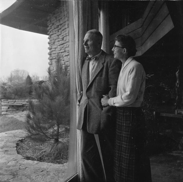 Journalist Herb Jacobs and his wife Katherine standing in the window of Jacobs II, the second home that Frank Lloyd Wright designed for them.