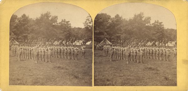 A group of soldiers stand at attention in formation as a part of the 1876 Centennial Celebrations.