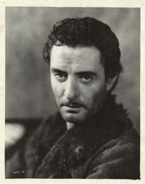 Head and shoulders publicity still of actor John Gilbert for the film Redemption which was released in 1930. He looks directly at the viewer and is wearing a heavy winter coat.
