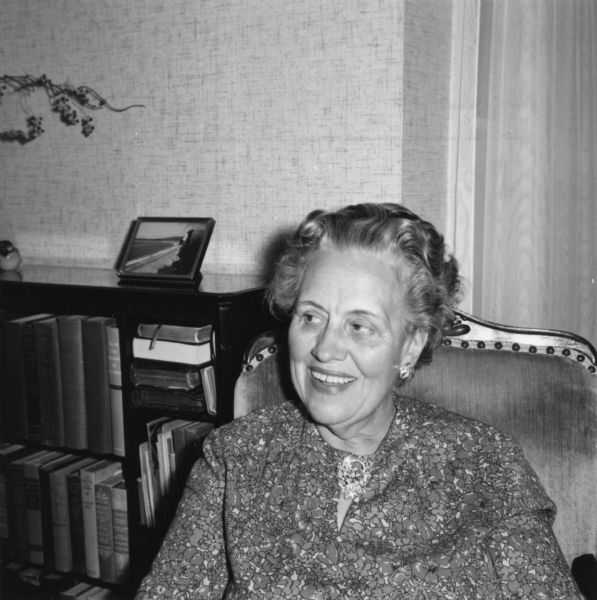 Portrait of Laura Graf seated in a chair at her home in Wauwatosa, Wisconsin. A bookcase is behind her.

Laura was born September 2, 1898 in Pewaukee (Waukesha Co.), Wisconsin, the daughter of Edward (b. 1862) and Theresa (b. 1870) Graf. Laura worked in clerical jobs and never married. She died July 20, 1964 in Wauwatosa.