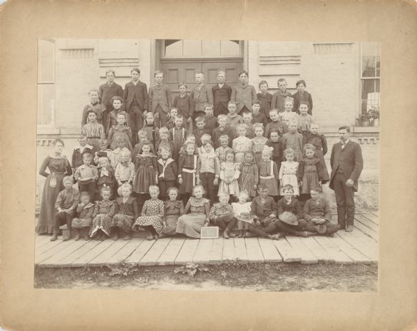 Students of the Slinger Grade School, pictured with their teachers, Miss Margaret O'Connell who taught grades one through five, and Mr. H.T. White who taught grades five through nine.