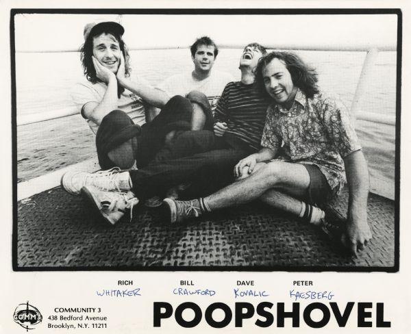 Publicity photograph of the four band members from Poopshovel, a Madison, Wisconsin rock band. From left to right are Rich Whitaker, Bill Crawford, Dave Kovalic, and Peter Kaesberg. They are pictured sitting on the wheelchair accessible fishing pier in Law Park on Lake Monona (currently the site of Monona Terrace).<p>Community 3 Records is mentioned on the photograph.
