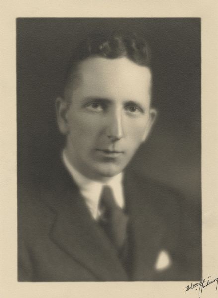 Quarter-length studio portrait of Robert B.L. Murphy wearing a suit and tie.