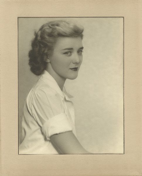 Quarter-length studio portrait of Suzanne W. Miles. She was the Curator of Archeology and Ethnology for the State Historical Society of Wisconsin from 1945 to 1947.