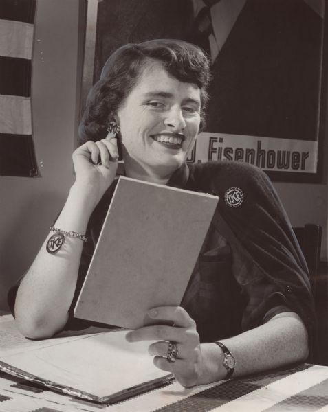A few pieces of "Ike" jewelry were modeled by Mrs. Russell Buck, Jr., of Fox Point. She worked at the headquarters of the Wisconsin Citizens for Eisenhower women's division.