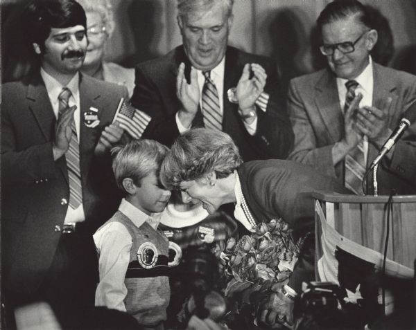 Geraldine Ferraro thanks a little boy and girl for giving her a bouquet of flowers after her speech.