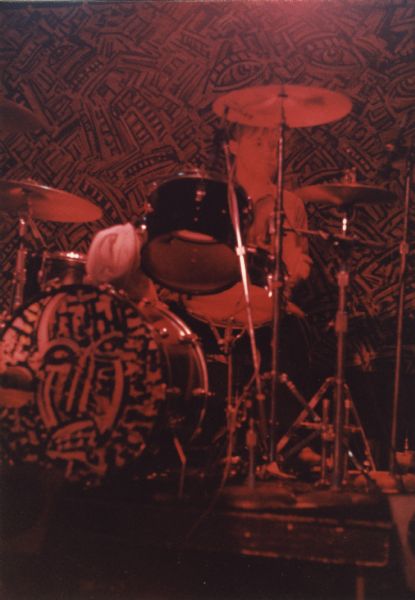 Butch Vig performing as part of the band Spooner. Madison, Wisconsin artist Dennis Nechvatel painted the bass drum head and the backdrop.