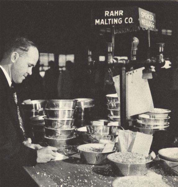 A buyer for the Rahr Malting Company of Manitowoc, Wisconsin inspects barley for sale at the Minneapolis Grain Exchange.