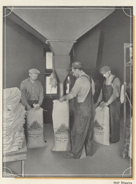 Three men packing malt sacks for shipping, Rahr Malting Company, Manitowoc, Wisconsin, 1934.