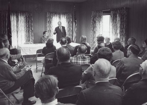 Wisconsin Senator Gaylord Nelson speaking to an audience in northern Wisconsin in behalf of the congressional campaign of David R. Obey who is seated to Nelson's right. Obey was running in a special election created when Melvin Laird was appointed Secretary of Defense.