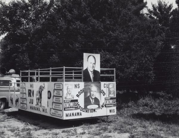 Parade float parked by the side of a road. It is advertising Republican candidates running for office. The portraits on the float are of Wisconsin Governor Warren Knowles (bottom) and Congressman Melvin Laird.