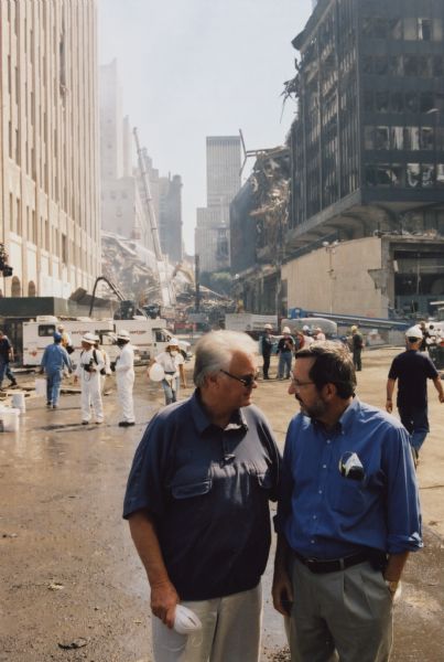 Congressman Bill Young of Florida (left), chair of the House Appropriations Committee, and Congressman David R. Obey of Wisconsin, the ranking committee Democrat, toured the World Trade Center site a few days after the 9/11 attack to see the damage first-hand. They are standing at the intersection of Vesey and West, between 6 World Trade Center and the Verizon Building, both of which were heavily damaged by the collapse of the twin towers. The 6 WTC building was ultimately razed; the Verizon Building, an architectural landmark, was restored.