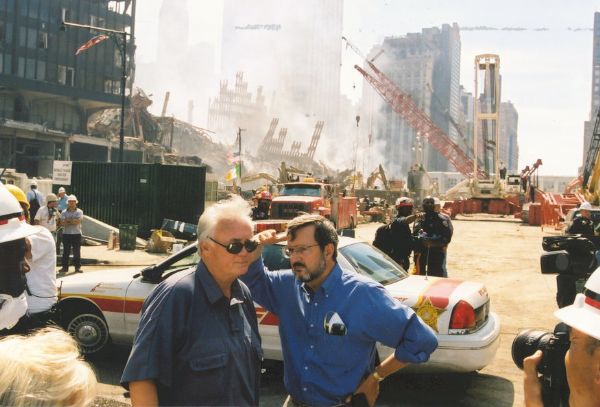 Florida Congressman Bill Young (left) and Wisconsin Congressman David R. Obey, respectively chairman and ranking Democrat on the House Appropriations Committee, touring the World Trade Center site a few days after the 9/11 attack. Young and Obey were there to survey the damage prior to authorizing federal funding for the recovery effort.  The two are thought to be standing at the corner of Vesey Street and West Side Highway in front of the ruins of 6 World Trade Center and the North Tower. In the center background is the Cass Gilbert-designed 90 West Street building. Although damaged by the collapse of the Twin Towers, 90 West Street was restored, winning an award for its preservation.
