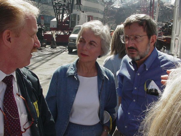 Wisconsin Congressman David R. Obey (right), with Joan Obey and an unidentified FBI agent, touring the World Trade Center site shortly after the 9/11 attack. Behind them is the debris pile of World Trade Center building 7 (7 WTC) which collapsed late in the afternoon of September 11. The left background is Fiterman Hall which was severely damaged by the collapse of 7 WTC and eventually razed.