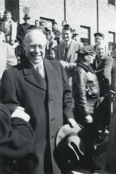 Robert A. Taft outdoors shaking hands in a crowd after giving a speech in the Municipal Building during his campaign. He was ultimately unsuccessful in his bid to be elected President. He served as Senator from Ohio from January 1939 until July 31, 1953. His father was President and Chief Justice William Howard Taft.