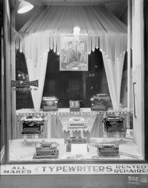 Brewington Typewriter Company, 533 State Street, window display featuring Royal typewriters and an adding machine. The name was later changed to Stemp Typewriter Company.