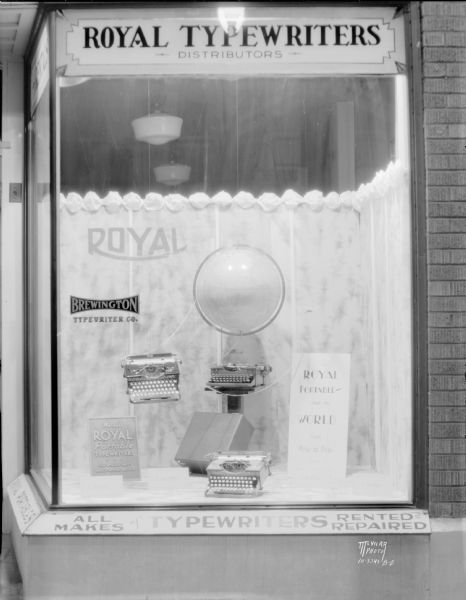 Royal Portable Typewriters on display in the window at Brewington Typewriter Company, 533 State Street. The name was later changed to Stemp Typewriter Company.