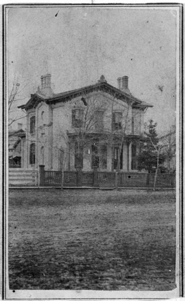 Carte-de-visite of local merchant Thaddeus Dean's residence, located at the intersection of Wisconsin Avenue and Gorham Street.