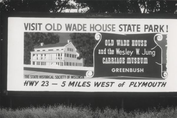 An advertising billboard for Old Wade House and the Wesley W. Jung Carriage Museum.