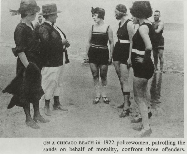 Caption below the illustration reads, "ON A CHICAGO BEACH in 1922 policewomen, patrolling the sands on behalf of morality, confront three offenders." Two policewomen, fully clothed and wearing shoes, confront four women in bathing suits, also wearing shoes. Two men, in bathing suits, look on from the background. The group is on a beach on Lake Michigan.