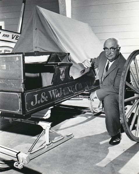 Wesley W. Jung poses by a sled built by the Jung Carriage Company for J&W Jung & Co. Department Store to make deliveries in Sheboygan during the winter.