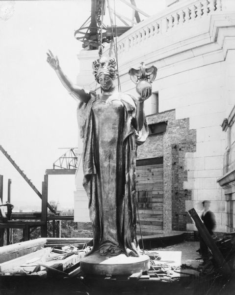 Raising the statue "Wisconsin" to the top of the dome of the Wisconsin State Capitol building.