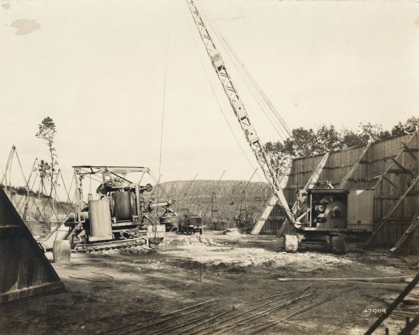 A building site with "O'Dea and Shafer, Engineers and Contractors" crane and other equipment. On the photograph album binding on the left side of the photograph is written "Reservoir at Madison."