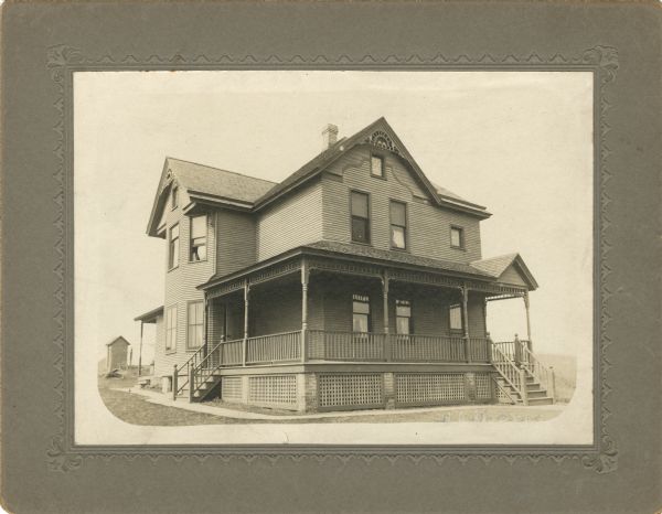 First O'Dea family home on Park Street. The house may have been built by Thomas Aquinas O'Dea. He and his family lived there until 1911 or 1912, when they built a new house, also on Park Street. A small building in the background on the left may be an outhouse.