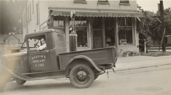 Lloyd Phillips poses in the delivery truck for Kasdin's Fancy Groceries & Meats at 402 West Lakeside Street.