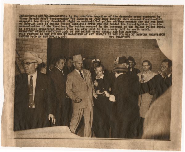 Original UPI Wirephoto transmission. Caption reads: "Dallas: This is the complete negative of the dramatic scene captured by Times Herald Staff Photographer Bob Jackson as Jack Ruby fatally shot accused Presidential assassin Lee Harvey Oswald. At right an unidentified police officer reaches for the gun hand of Ruby. At left is Dallas Police Capt. Will Fritz who had headed the investigation into the assassination of the President. The action occured [sic] in the basement of the Dallas Police Dept. as officers transfered [sic] Oswald from the city jail to the county jail to await trial."