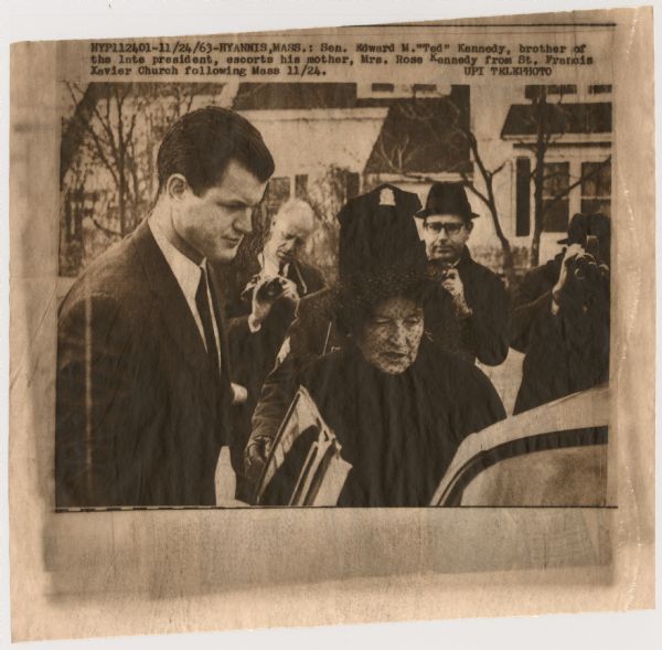 Original UPI Wirephoto transmission. Caption reads: "Sen. Edward M. "Ted" Kennedy, brother of the late president, escorts his mother, Mrs. Rose Kennedy from St. Francis Zavier Church following Mass 11/24."