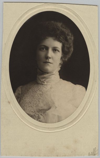 Quarter-length oval studio portrait of Laura (Smith) Kaun. She is wearing a lace dress or blouse with a high collar.

Laura was born April 9, 1876 in Milwaukee, the daughter of Amos Appleton Lawrence Smith (1849-1906), a lawyer (attorney for Captain Frederick Pabst), and Frances Louise Brown (1851-1891). On January 29, 1902, Laura married William A. Kaun (1875-1922), a German immigrant, who founded and owned the William Kaun Music Co. in Milwaukee. After William's death Laura became president of the company. She died Februray 15, 1937.
