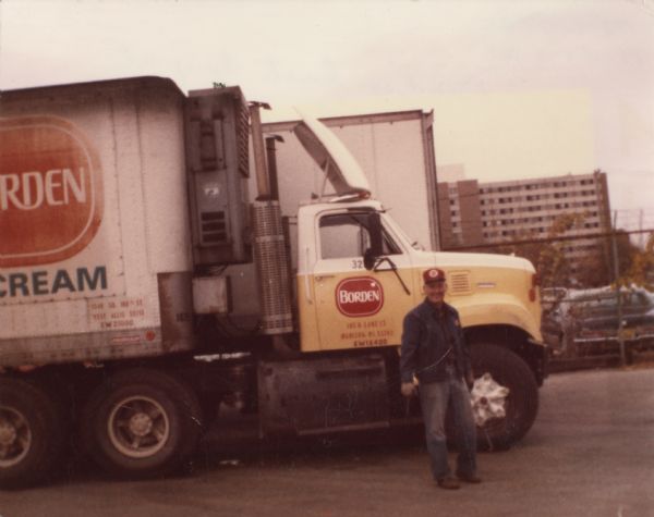 Elwin "Al" Smith stands in front of his Borden's delivery truck on his last day before retirement. A University of Wisconsin dormitory and a parking lot are in the background.

Elwin was born August 9, 1924 in Madison, Wisconsin, the son of Russell Smith and Ethel Taylor.  On September 8, 1945 he married Mary Catherine Clemens (1923-1989).  At the time he was employed by Winnebago Auto Replacement.  On September 3, 1952 he began working for Borden's Dairy.  In the late 1970s home milk delivery ceased, so Elwin drove a semi-truck for Borden's until his retirement on October 1, 1982.  At the time of his retirement he was making $9.25/hour and his average earnings for the past five years had been $20,362.19.  After retirement he drove a school bus and delivered Owl's Nest cheese out of Poynette.  His last job was working as a janitor for Suttle Press.  Elwin died on June 7, 2002 in Madison.