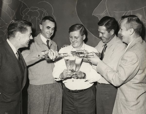 William R. "Bill" Kinney (1912-1978; second from left) and friends enjoy a beer at the Miller Brewery. Bill and his brother Howard Kinney owned the White Front Tavern in Waterloo, Wisconsin from 1948-1956. They were invited to tour the brewery along with several of their customers.