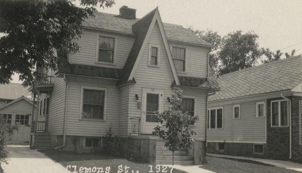 Photographic postcard view from street of the house at 607 Clemons Street. The residence was built by Willard Droster. Caption reads: "607 Clemons St., 1927."