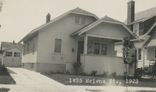 Photographic postcard view from street of the house at 1835 Helena Street, and the garage behind it on the left, both built by Willard Droster. Caption reads: "1835 Helena St., 1929."
