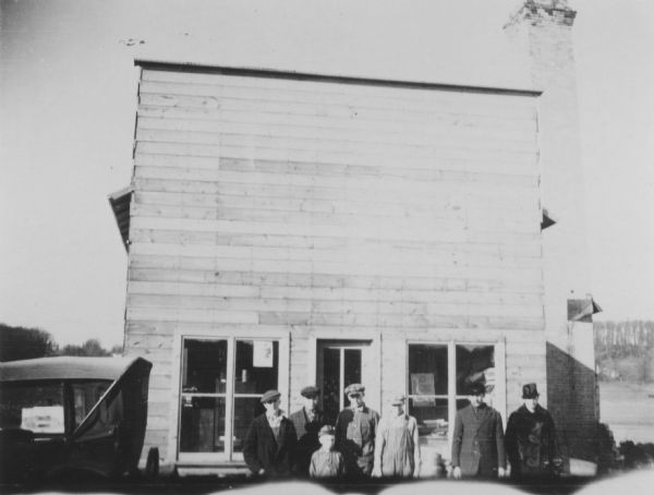 Temporary building built after the fire in Burke that destroyed the Droster Brothers General Store. The Droster's bought out John Quilty's store, which in the 1950s became the Burke Station Tavern. The children are posed with their parents, William and Helen Droster.