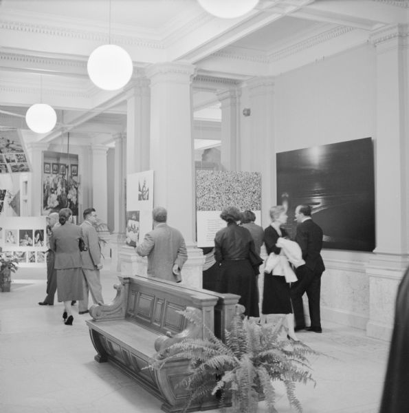 Guests at the evening opening party for the "Family of Man" photographic exhibition, at the State Historical Society of Wisconsin. The exhibition was organized and circulated by the Museum of Modern Art, of New York. About 300 attended the opening.