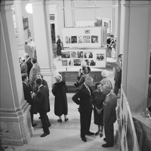 Guests at the evening opening party for the "Family of Man" photographic exhibition, at the State Historical Society of Wisconsin. The exhibition was organized and circulated by the Museum of Modern Art, of New York. About 300 attended the opening.