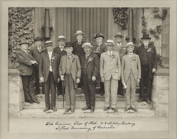 Handwritten caption reads: "Sole Survivors, Class of 1866. U.S. Military Academy. Fiftieth Anniversary of Graduation." Twelve men are lined up in two rows on the stone steps in front of a double door. Ivy is on the walls flanking the doorway, along with two cannons mounted vertically. The men are wearing suits, hats and their military decorations. Identities are handwritten below each of the men, (back row, l to r), Charles King, Charles S. Smith, Charles E.L.B. Davis, Robert Craig, Henry H.C. Dunwoody, William H. Upham, James B. Cole, (front row, l to r), Francis L. Hills, Abner H. Merrill, Daniel W. Lockwood, Samuel R. Jones (Class of 1867), and Hiero B. Herr.