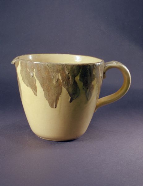 Pauline pottery cup with lip and handle.