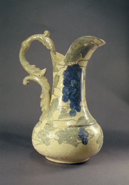 Pauline pottery pitcher decorated with grapes and grapevines.