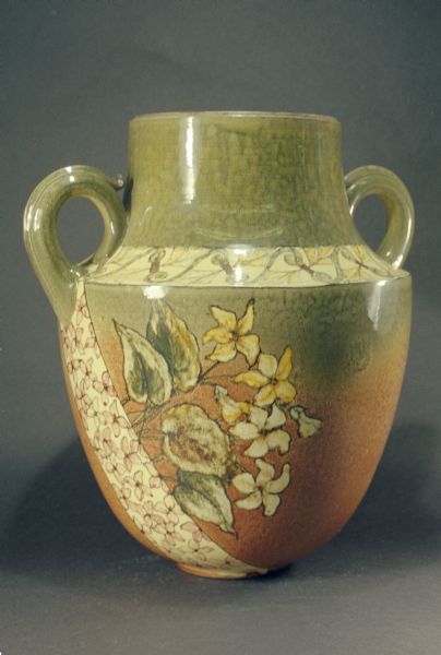 Pauline pottery jug with two handles.