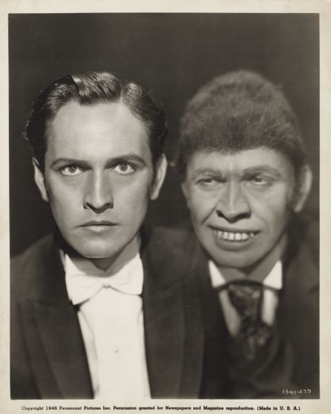Fredric March appears as both Dr. Jekyll and Mr. Hyde in a publicity photograph for the Paramount film. March as Dr. Jekyll wears a tuxedo. Mr. Hyde wears a suit with tie, has large teeth and bushy hair.