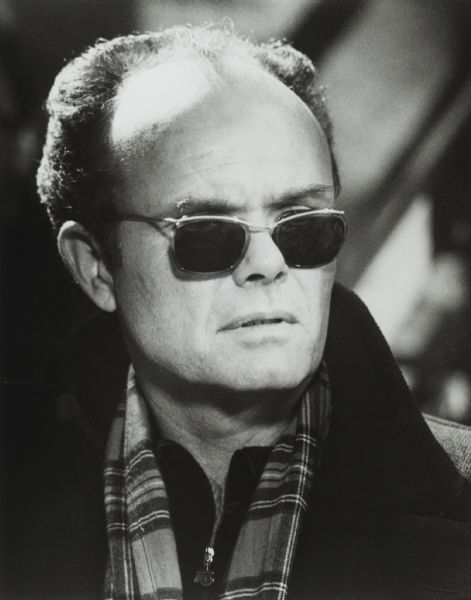 Publicity photograph of Kurtwood Smith as the villain Mr. Sue in the television show <i>The New Adventures of Bean Baxter</i>. He is wearing sunglasses, a coat and a scarf.